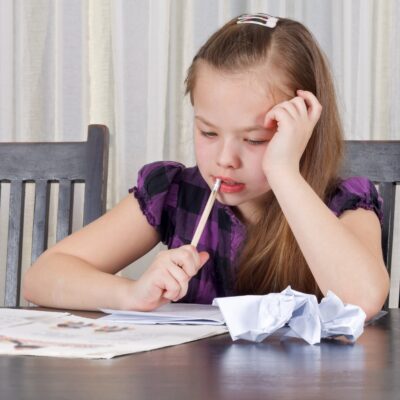 Tween aged girl struggling to do homework